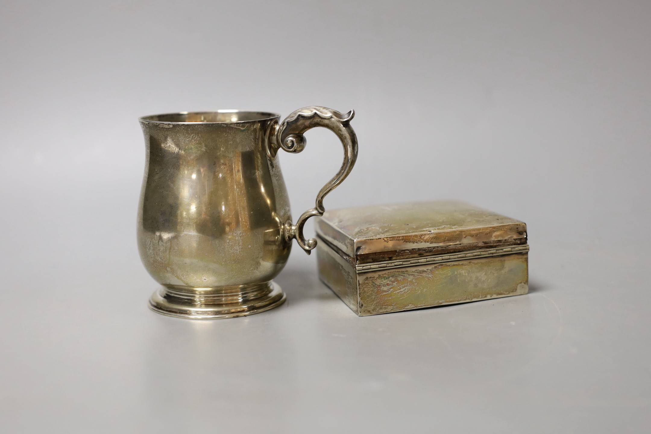 A George V silver christening mug, London, 1934, 95mm and a silver mounted cigarette box.